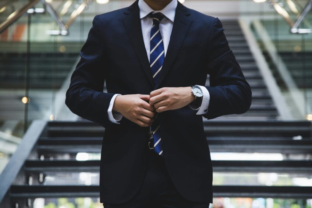 A man in a suit and tie standing on stairs