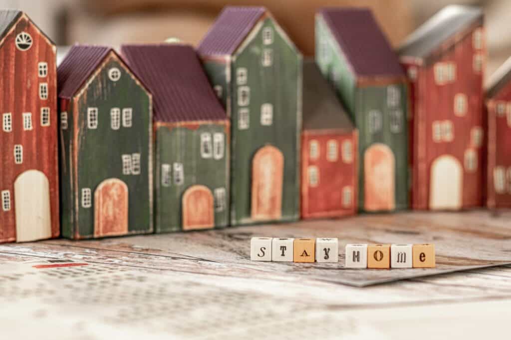 Small wooden houses on a map with the word home